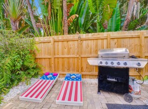 Enjoy playing corn holes while cooking in the griller