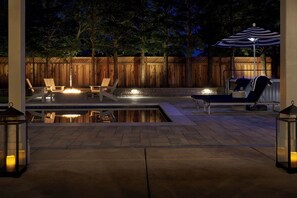 Backyard paradise: heated pool, spa, outdoor shower, BBQ, corn hole & fire pit.