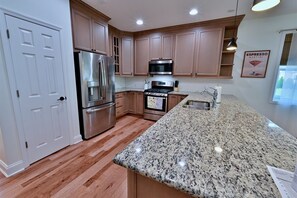 Chef-inspired kitchen features stainless steel appliances, dishwasher, disposal, refrigerator withthrough-the-door ice maker and water, natural gas stove, and coffee maker.