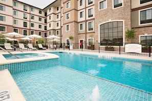 Lounge by the pool in the sunshine.