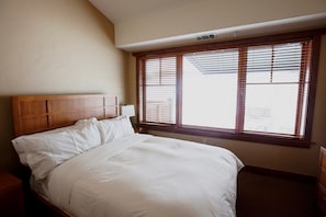The master bedroom features a comfortable king bed and TV.