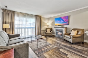A stylish and cozy living space featuring warm tones, plush seating, and a fireplace—ideal for relaxing evenings.