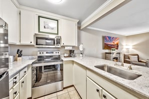 A well-equipped kitchen with modern appliances, sleek countertops, and an open layout, perfect for preparing meals with ease.