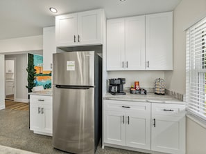 This stylish coffee bar features a dual Keurig system for drip coffee and single-serve cups, offering both hot and cold beverage options. Sleek storage keeps Keurig cups, creamers, and sweeteners organized, blending style and functionality for your coffee breaks.