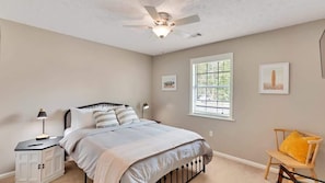 Guest bedroom with smart TV and phone charging stations