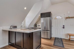 This apartment features a full kitchen with refrigerator, stove top, oven, dishwasher and microwave.