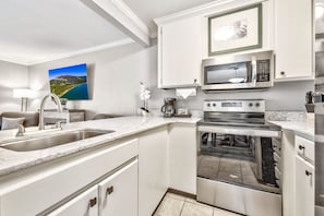 A bright and functional kitchen with modern touches, offering the perfect space to prepare delicious meals in a home-like setting.