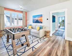 The third-floor bonus room features seating and a game table (either foosball, air hockey, or pool) and provides the perfect hang-out spot for the kids.