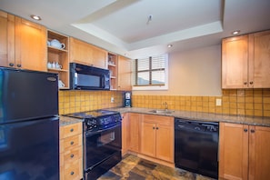 The gourmet kitchen comes fully-equipped for your convenience.