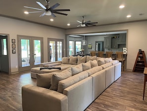 Living area with large sectional and 85" smart TV