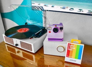 Record player & 14 albums. Polaroid camera available + film for purchase.