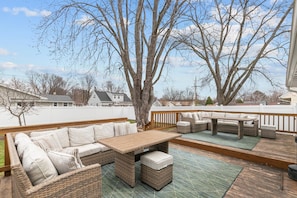 Sunny and spacious back deck ready for grilling, dining, and fun.