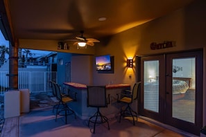 Relax on the covered patio with ambient lighting