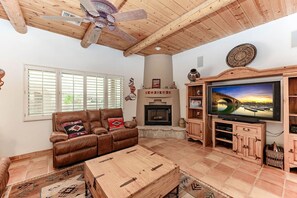 Cozy living room with smart TV (stream your favorite apps), comfy recliners, and a warm fireplace—perfect for relaxing nights in.