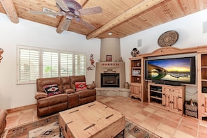 Cozy living room with smart TV (stream your favorite apps), comfy recliners, and a warm fireplace—perfect for relaxing nights in.