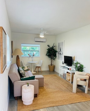 Stylish living room with dining nook and convertible sofa