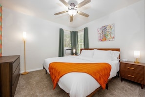 King bed, bedside tables with lamps, chargers and six drawer dresser and closet