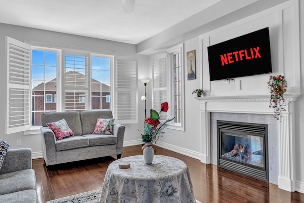 Spacious living room ☀️ Smart TV & fireplace ✨ Bright, cozy & perfect to unwind!