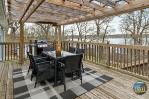 Large deck with outdoor seating and grill for cooking out