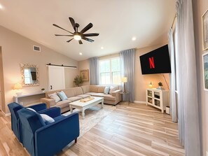 Living Room: 65" Roku TV, games, Queen sleeper sofa - perfect for game night!