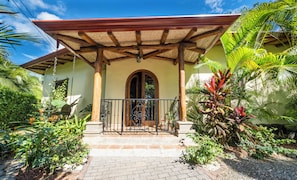 Elegant arched doors, warm wood, and decorative features greet you at the entry.
