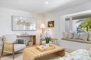 Living room w/ ample seating and large smart TV.