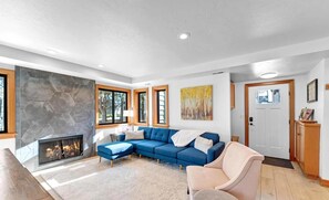 Unwind by the fireplace in this cozy, inviting living room.