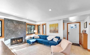 Unwind by the fireplace in this cozy, inviting living room.