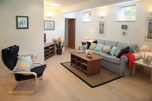 Curl up with a film or a book — the lounge includes a smart TV, WiFi, and plenty of natural light.