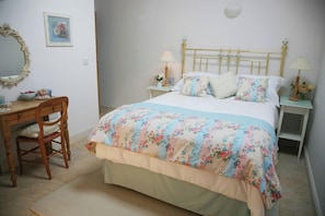 A cosy double bedroom with garden views and its own private ensuite — perfect for slow mornings and early nights.