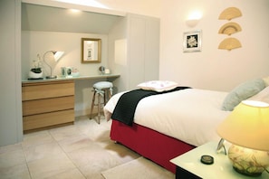 The second bedroom, featuring a comfy double bed and its own ensuite with shower — ideal for couples or friends sharing.