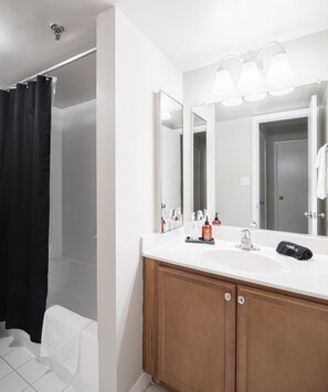 After a busy day, you’ll appreciate unwinding in this pristine bathroom, complete with a refreshing shower and all the plush towels you’ll need.