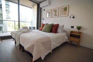 Bright and cozy bedroom with modern decor and stunning views, perfect for a relaxing getaway.