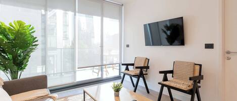 Bright and modern living room with large windows, perfect for relaxing and enjoying the view. A cozy space to unwind after a day of adventures!