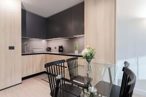 Experience modern elegance in this fully equipped kitchen, perfect for culinary adventures and cozy dining moments.