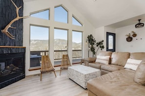 Step into vaulted ceilings, with a floor to ceiling black stone fireplace and elk antler.