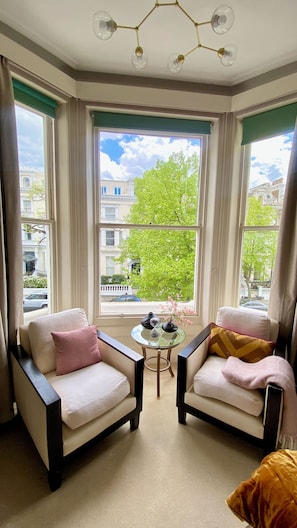 Enjoy sitting in the window onto a quiet tree-lined street with a good book