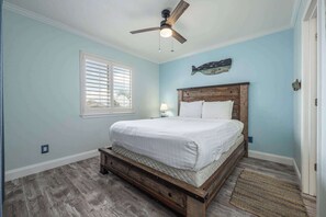 The serene bedroom features a plush queen bed & shared ensuite
