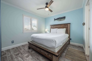 The serene bedroom features a plush queen bed & shared ensuite