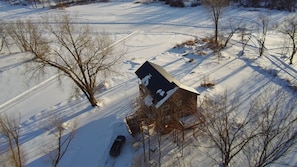 A birds eye view of the Treehouse on the Point facing the frozen Lake Pokegama