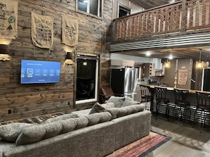 Spacious open-concept cabin blending rustic charm with modern comfort! Full bath on the main level, plus a dining area and island bar seating for 4 at the bar, and 6 at the dining table - perfect for gatherings!