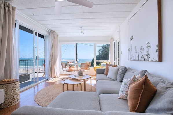 Settle into the oversized L-shaped sofa in the sun-drenched living area and unwind with a film, as ocean views and coastal breezes set the perfect backdrop.