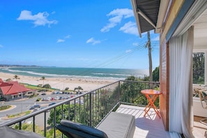 The main balcony off the living room is made for slow mornings and sunset wind-downs, with lounge seating and sweeping views across Kirra’s golden sands and pristine shoreline.