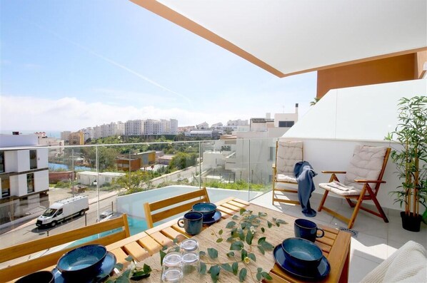 Beautiful south-facing terrace with outdoor dining area for four and comfort seating for two guests