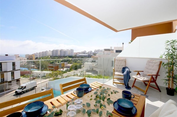 Beautiful south-facing terrace with outdoor dining area for four and comfort seating for two guests