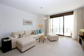 Another view of the modern and bright lounge with comfortable seating for four guests
