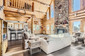 Main level living room with stone fireplace