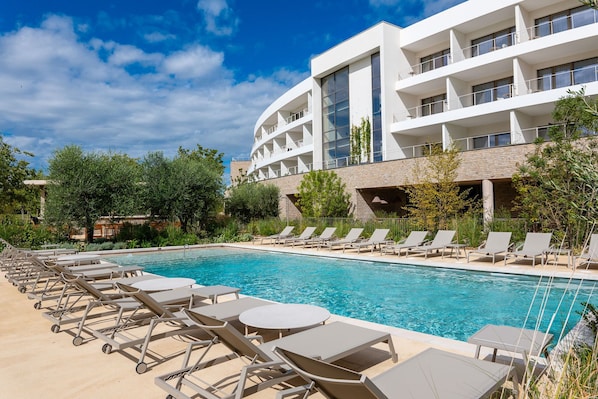 Unwind poolside with ample loungers and serene views of the Horizon Resort’s elegant modern architecture.