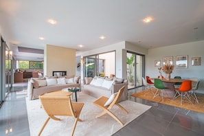 Open-concept dining and living space filled with natural light—designed for relaxing and entertaining with ease.