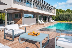 Poolside deck with chic loungers—ideal for sunbathing and soaking in the tranquil garden surroundings.